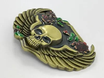 Angle View Decorative belt buckle with skull design and floral elements on a white background