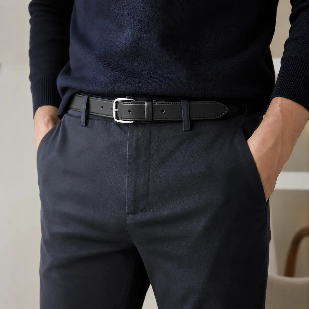 Person wearing navy sweater and pants with a 25mm black leather belt.