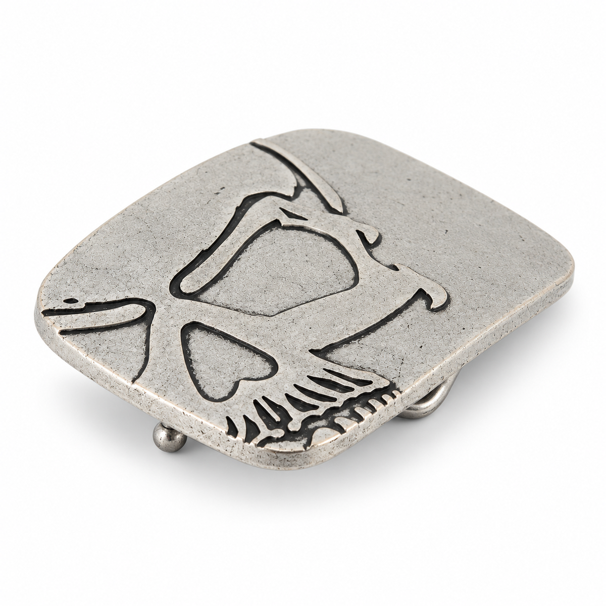 Angled view of silver cutaway skull belt buckle showing raised metal detailing