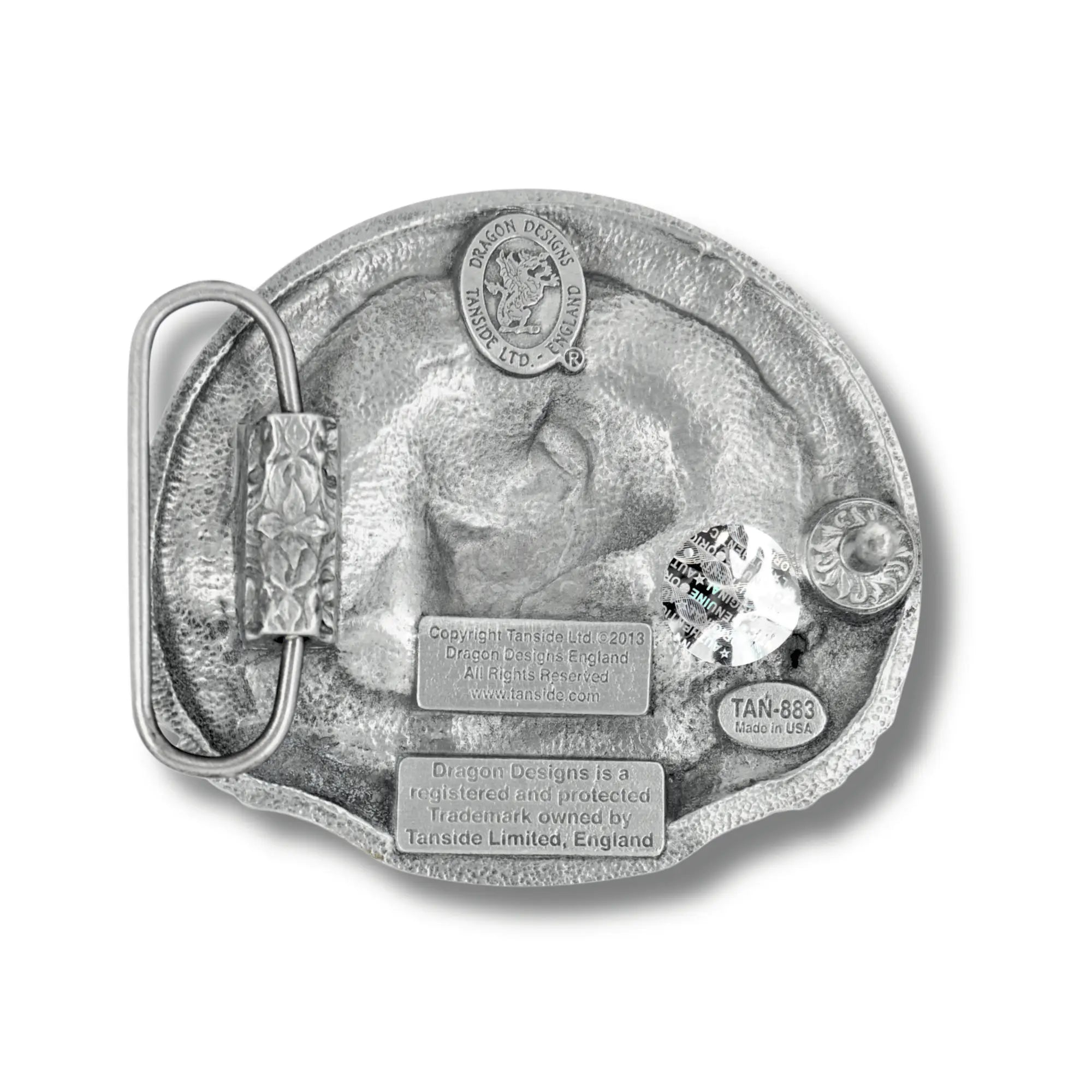 Metallic belt buckle with detailed design on a white background