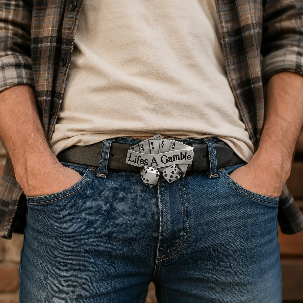 Person wearing a belt with a 'Life's a Gamble' buckle, plaid shirt, and jeans.