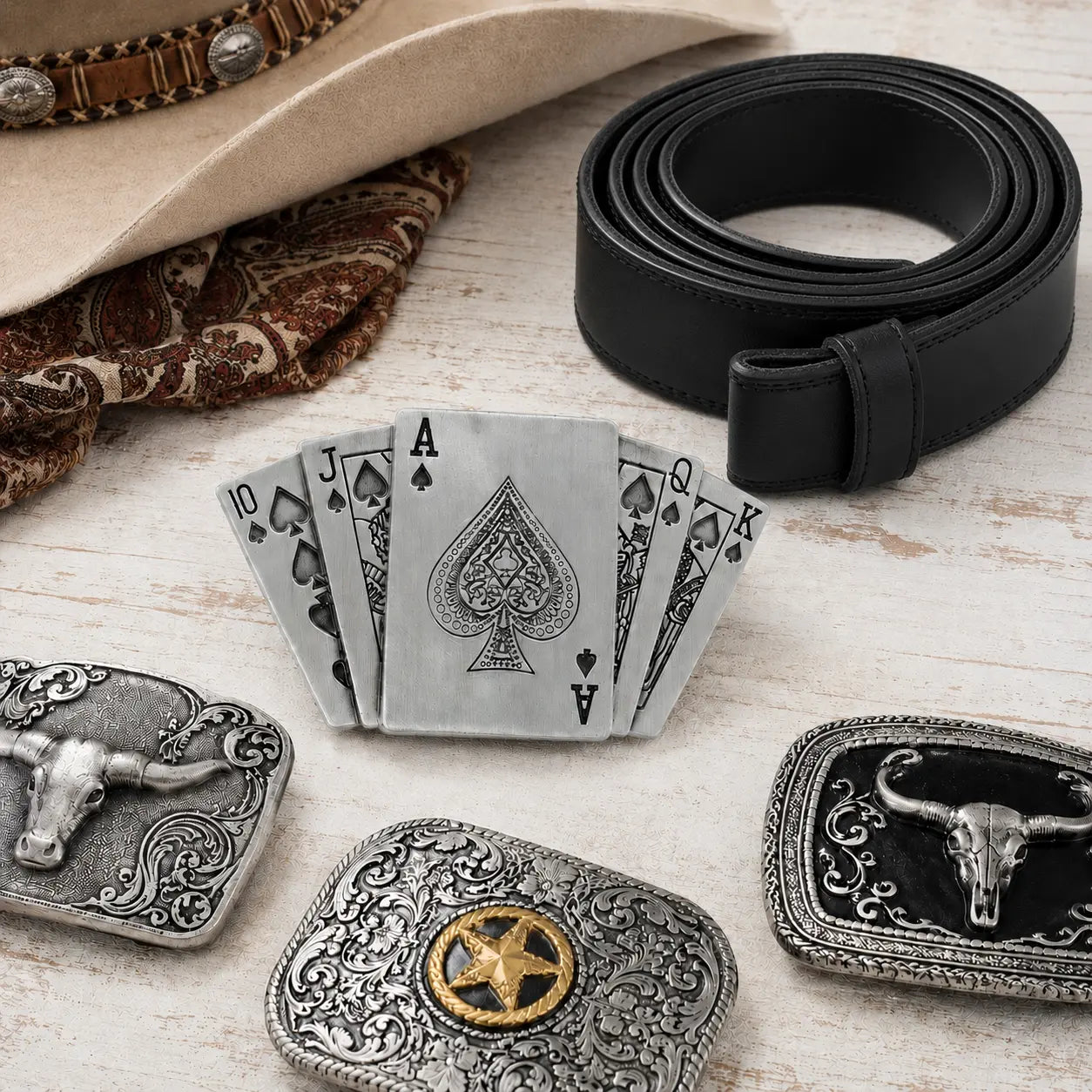 Playing cards belt buckle on a dressing table with belt and accessories.