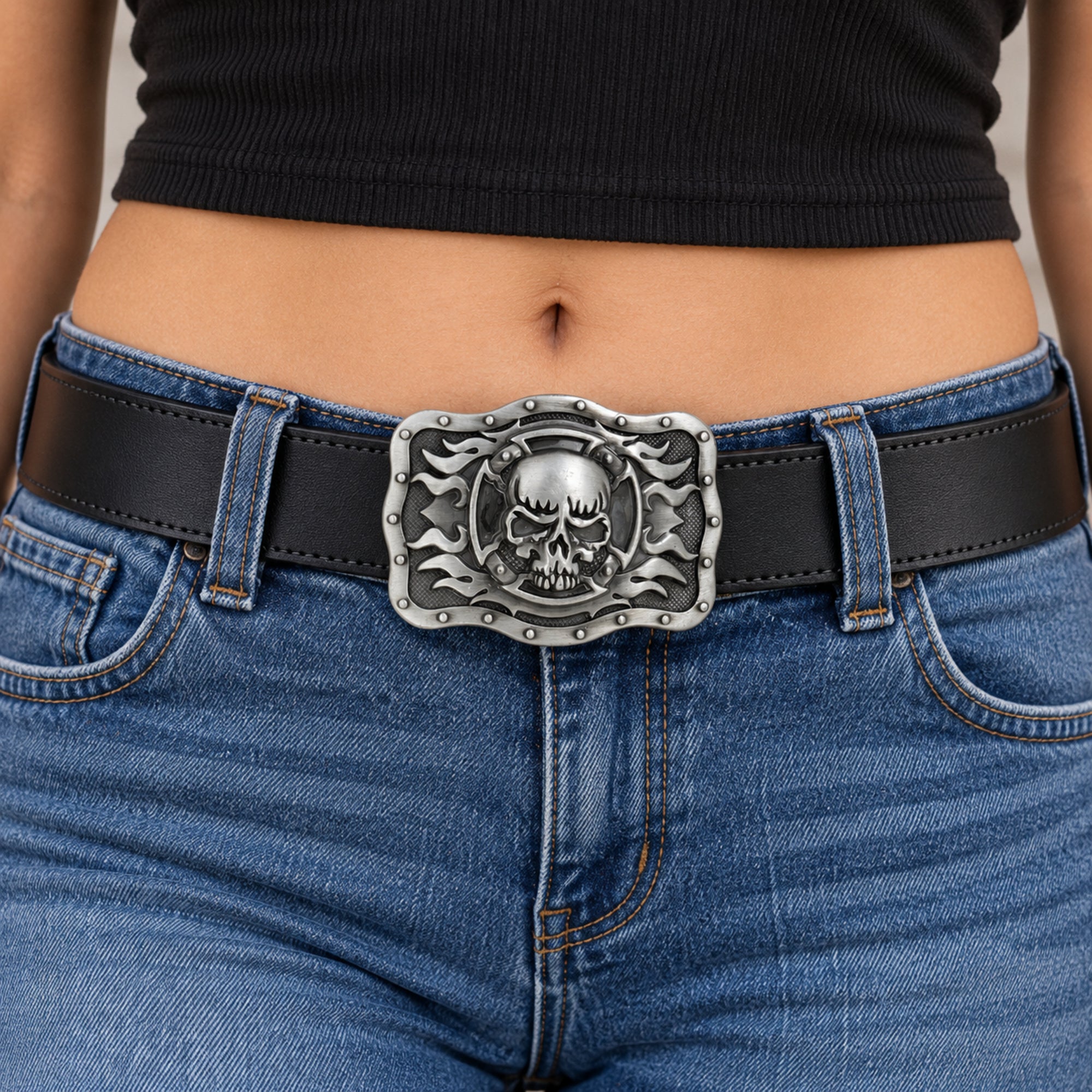 Grey skull and flames belt buckle worn on a black leather belt