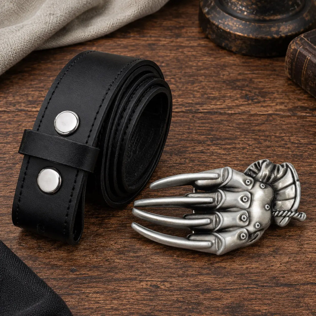 Razor glove belt buckle horror claw design, flat lay product photo