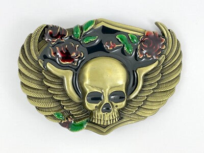 Decorative belt buckle with skull design and floral elements on a white background