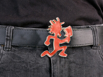 Red Kokopelli figurine belt buckle on a black leather belt