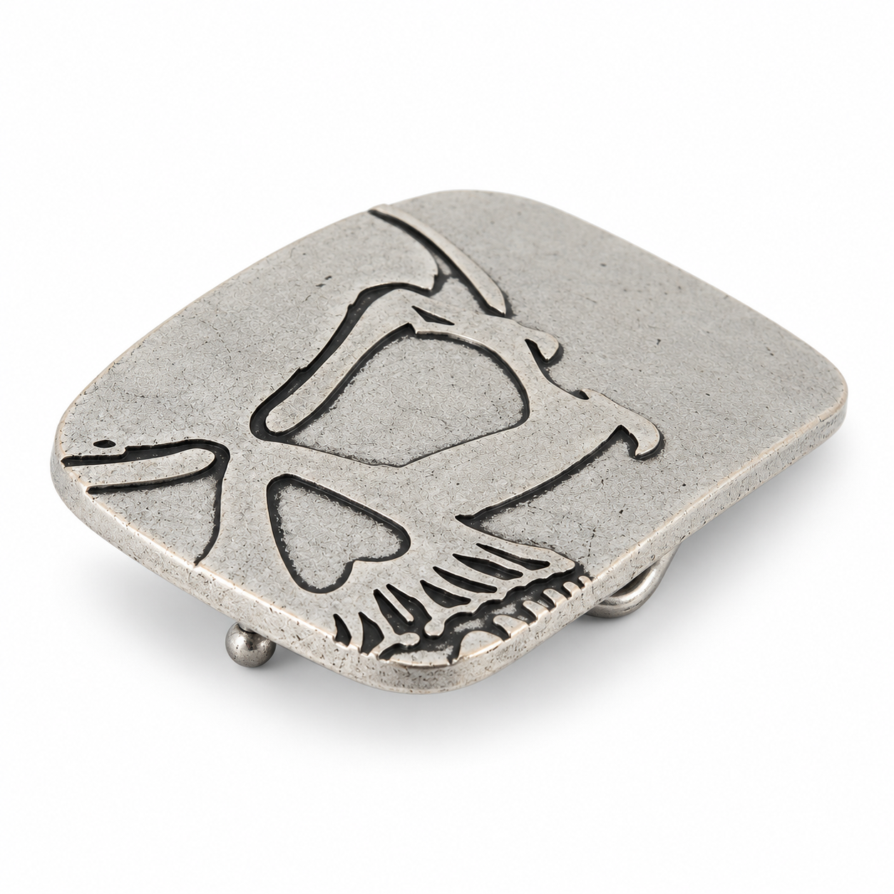 Angled view of silver cutaway skull belt buckle showing raised metal detailing