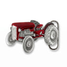 Red tractor belt buckle on a white background