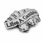 Silver belt buckle with 'Life's a Gamble' and dice on a grey background