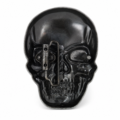 rear of a  skull-shaped belt buckle with belt clasp on a white background
