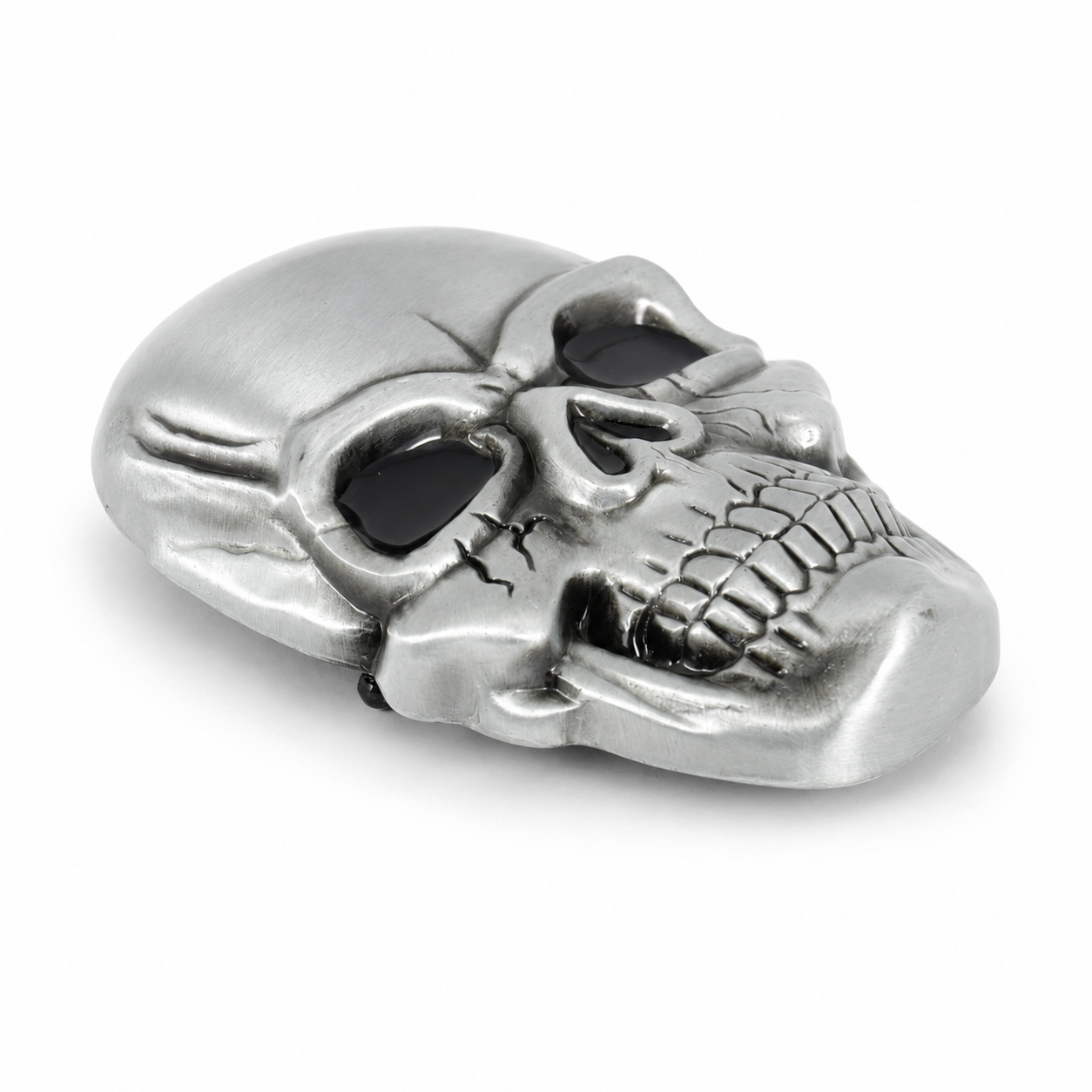Silver skull belt buckle on a white background