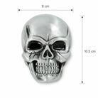 Silver skull-shaped belt buckle with dimensions indicated on a white background