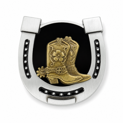 Decorative metal horseshoe belt buckle with gold cowboy boot and black background