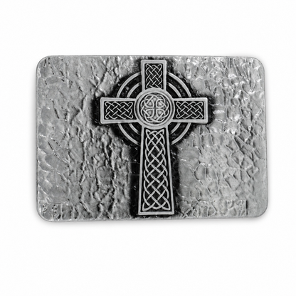 Metallic Celtic cross belt buckle on a textured stone-like background