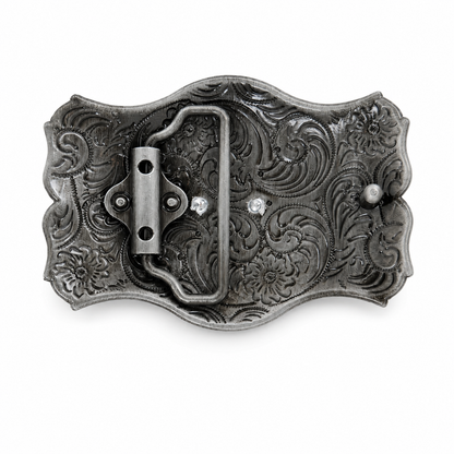 Rear of a belt buckle with intricate patterns on a white background