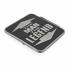 A rectangular black belt buckle with a silver metallic border and a bold silver design featuring the text 'THE MAN THE LEGEND' between two lightning bolts, shown on a plain white background.