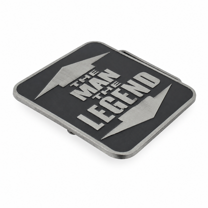 A rectangular black belt buckle with a silver metallic border and a bold silver design featuring the text 'THE MAN THE LEGEND' between two lightning bolts, shown on a plain white background.