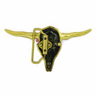 A metal belt buckle shaped like a longhorn skull, shown against a plain white background. The front features a polished brass/gold-toned finish with a black recessed interior and a small red accent near the hinge.