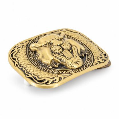 Angled view of antique gold tiger belt buckle showing raised detailing
