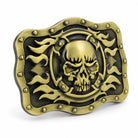 Angled view of bronze/gold skull and flames buckle showing raised detailing