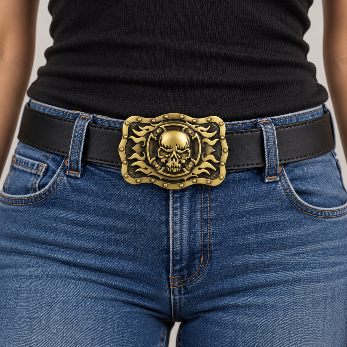 Bronze/gold skull and flames belt buckle worn on a black leather belt