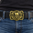 Bronze/gold skull and flames belt buckle worn on a black leather belt