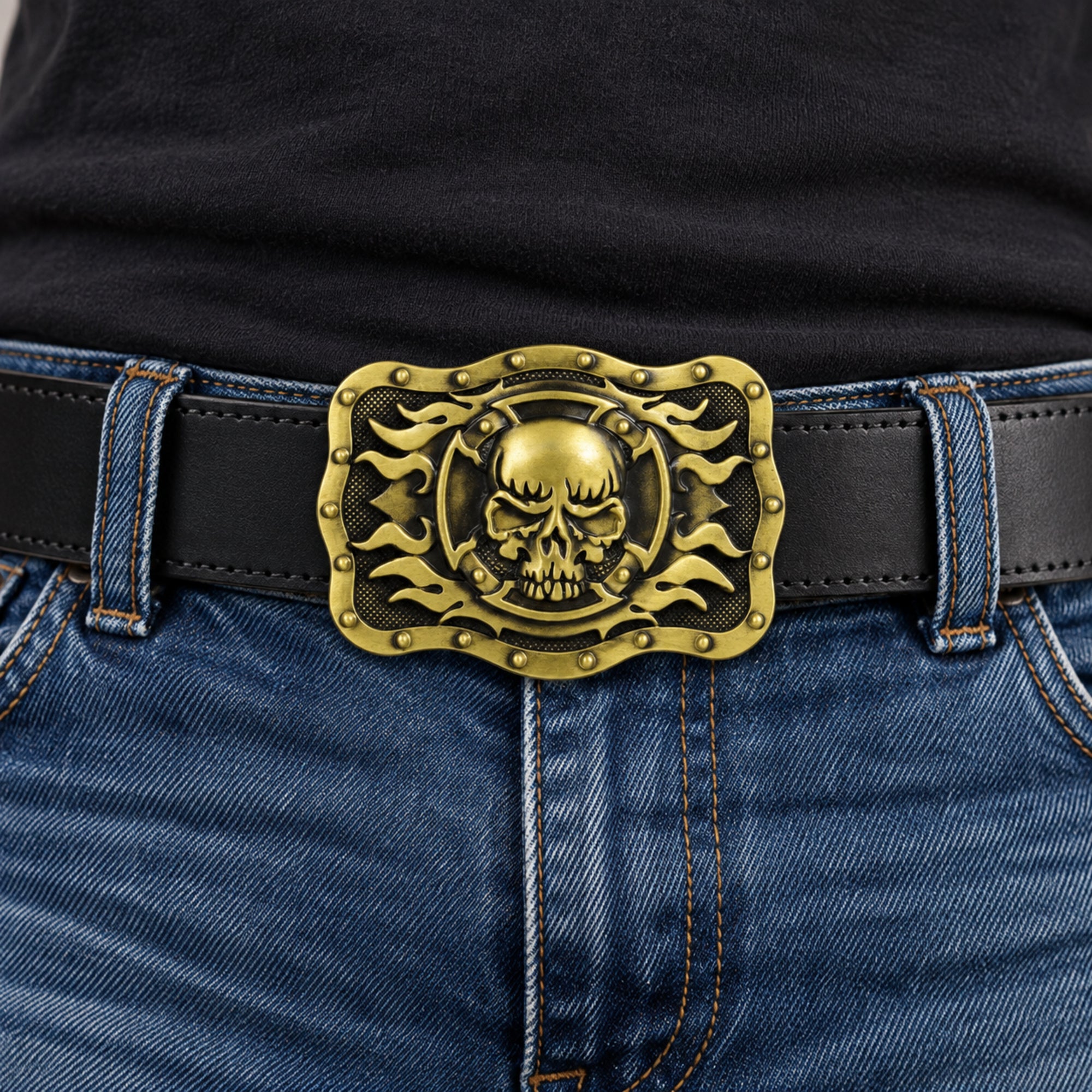 Bronze/gold skull and flames belt buckle worn on a black leather belt