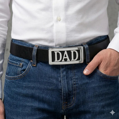Person wearing a belt with a 'DAD' belt buckle, dressed in a white shirt and blue jeans.