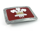 Welsh belt buckle with white prince of wales feathers on a red enamel background.